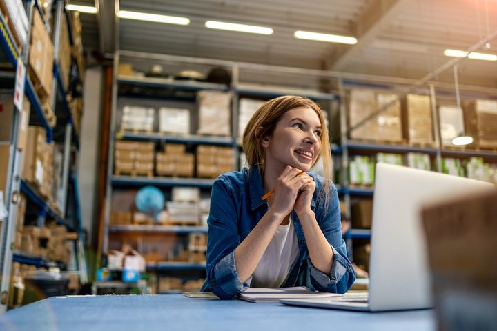 Woman working on her laptop in a sorting center